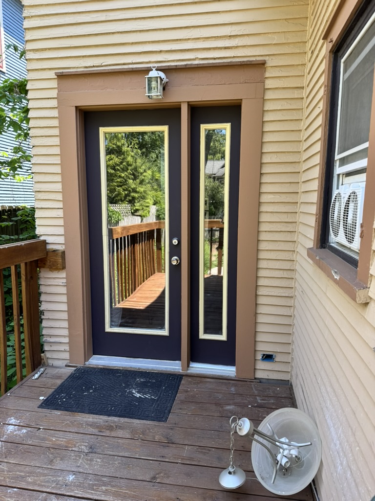 Refinished exterior entry door with fresh paint and trim, West Michigan — after