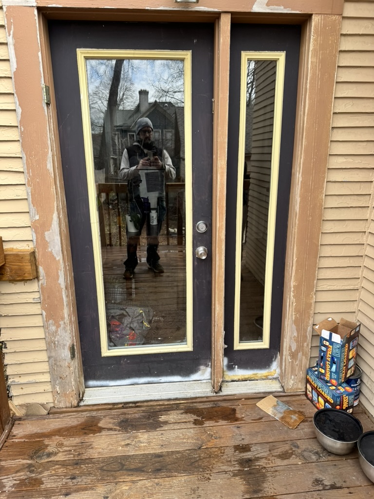 Weathered exterior entry door with peeling paint, West Michigan — before